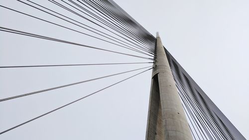 Low angle view of suspension bridge against clear sky