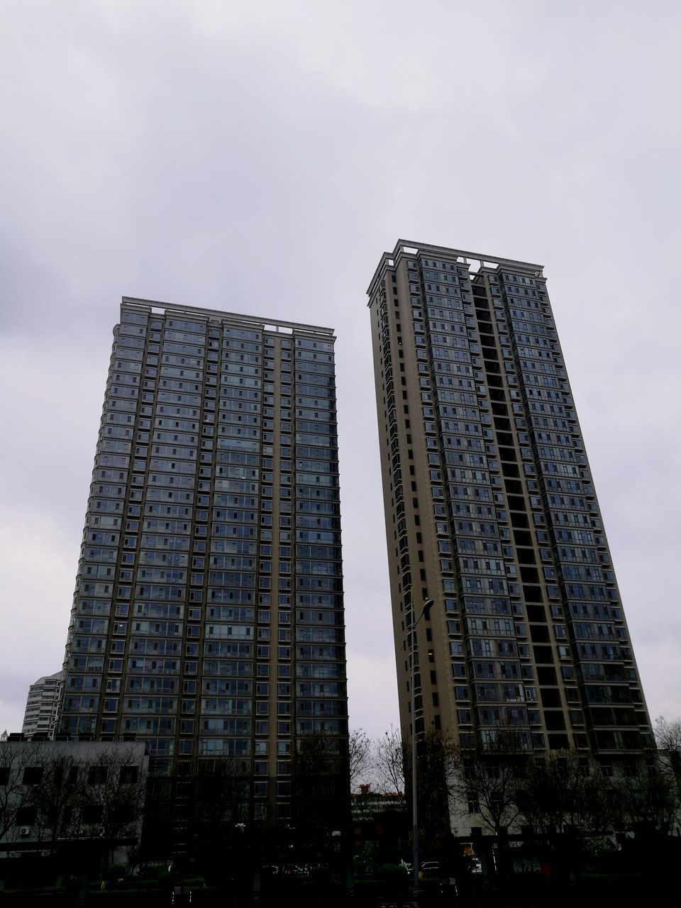 low angle view, architecture, sky, built structure, building exterior, city, day, outdoors, skyscraper, no people, tower