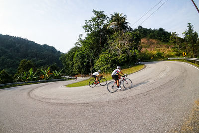 Man riding bicycle on road