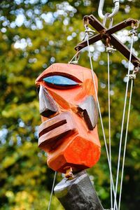 Close-up of toy hanging on pole in field