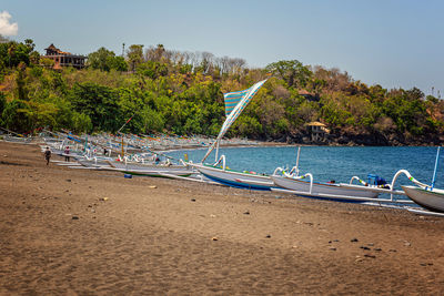 Amed village, black sand beach an traditional balinese boats on it. bali, indonesia