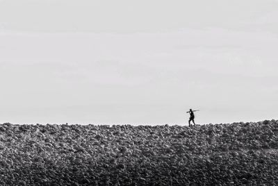 Man standing in field against sky