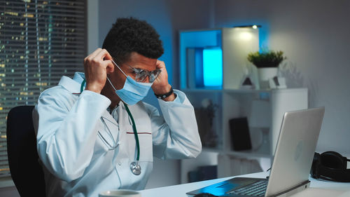 Doctor using mobile phone in laboratory