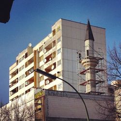 Low angle view of office building against sky