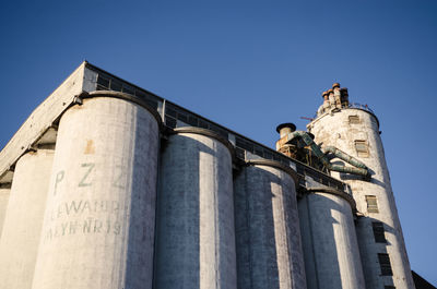 Low angle view of historic building against clear blue sky