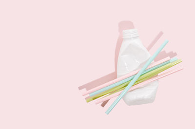 High angle view of colorful drinking straws against white background