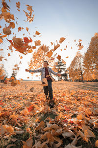 Full length of person standing by tree during autumn