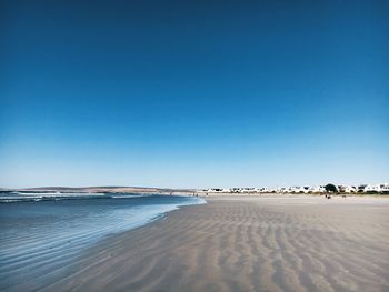 View of beach against blue sky