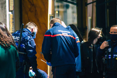 Rear view of people walking in city