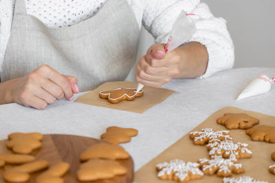 Midsection of woman holding jigsaw puzzle at home