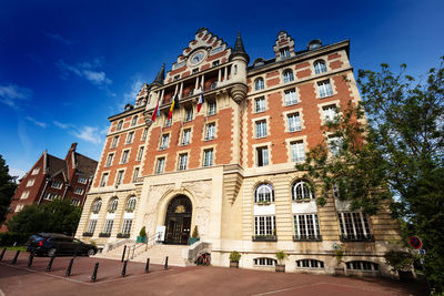 Low angle view of historical building against blue sky