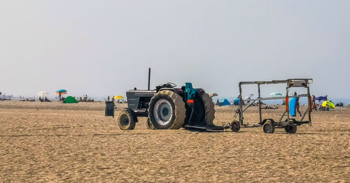 Tractor on field against clear sky