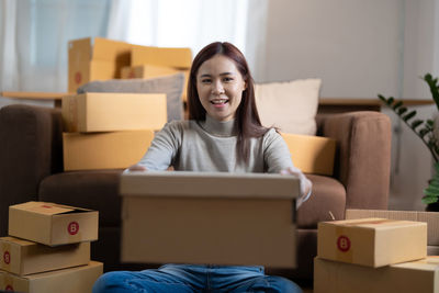 Portrait of young woman using laptop at home