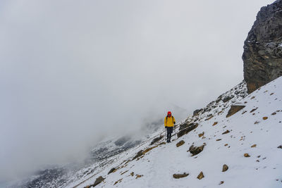 People skiing on snow covered mountain