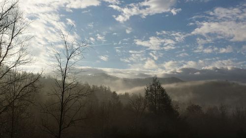 Scenic view of mountains against cloudy sky