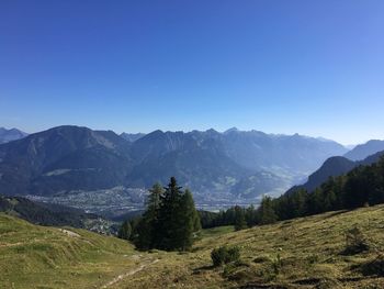 Scenic view of mountains against blue sky