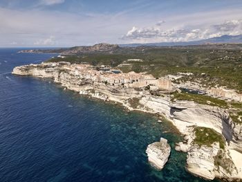 High angle view of buildings and sea against sky