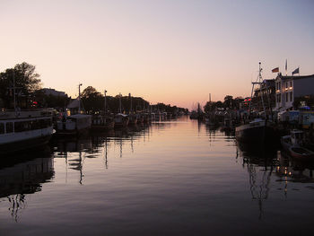 Boats in harbor at sunset