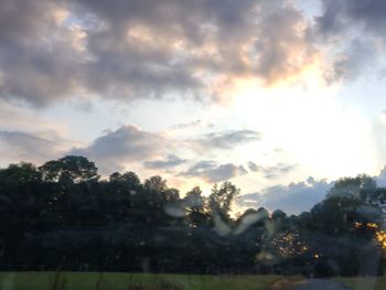 Scenic view of trees against sky during sunset
