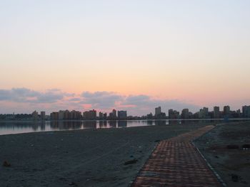 Scenic view of buildings against sky during sunset