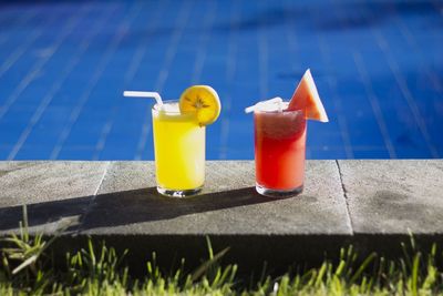 Close-up of drinks by the pool