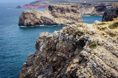 Scenic view of rock formation in sea against sky