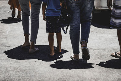 Low section of people walking on street