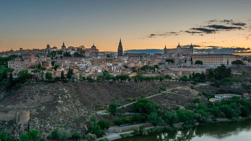 Buildings in city at sunset