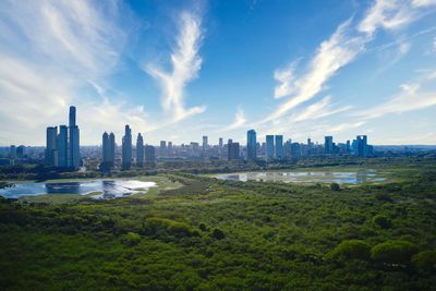 Buildings in city against cloudy sky