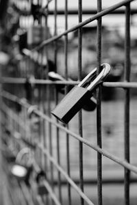 Close-up of padlock hanging on railing