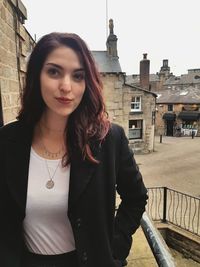 Portrait of a beautiful young woman standing outdoors