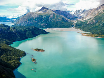 Scenic view of lake and mountains against sky