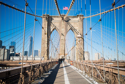 View of suspension bridge against blue sky