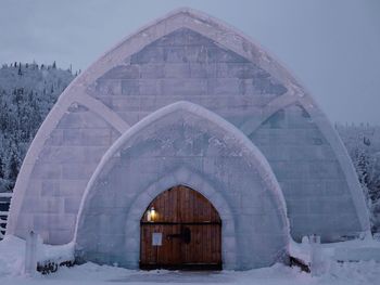 Built structure in winter against sky