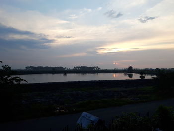Scenic view of lake against sky during sunset