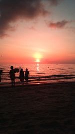 People on beach at sunset
