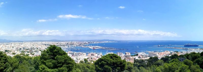 High angle view of townscape by sea against sky