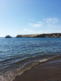 Scenic view of sea against blue sky