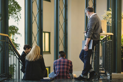 Creative business people on staircase in office