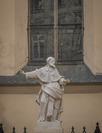 Low angle view of statue against building