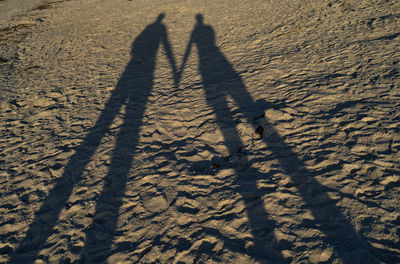 Shadow of people on sand