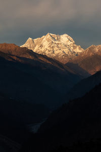 Scenic view of snowcapped mountains against sky at night