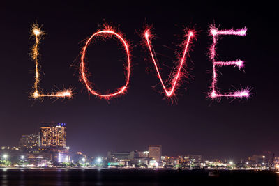 Firework display in city at night