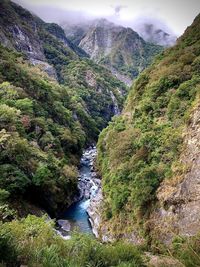 Scenic view of river amidst mountains against sky