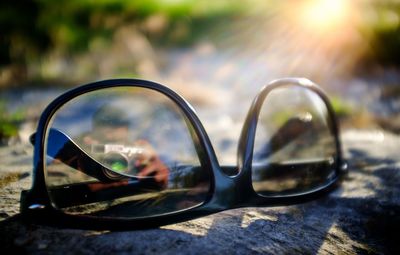 Close-up of sunglasses with reflection on mirror