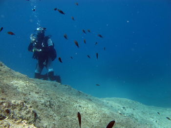 Man gesturing ok sign while swimming undersea