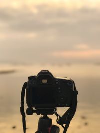 Close-up of camera against sky