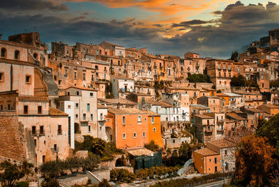 High angle view of buildings in town against sky