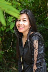 Portrait of smiling young woman standing outdoors