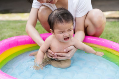 High angle view of boy playing in pool